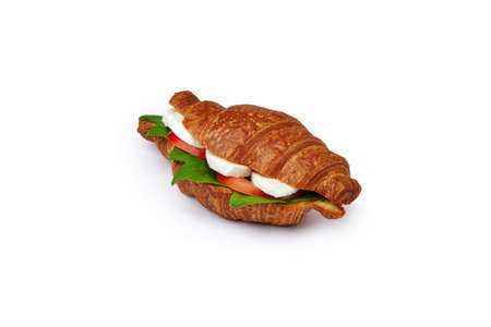 Croissant sandwich with feta and tomatoes isolated on whiteの写真素材