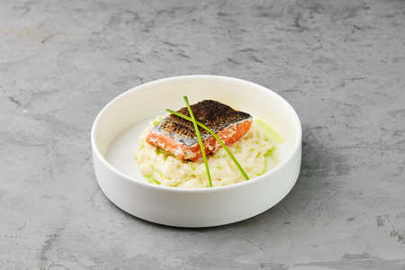 Red fish with garnish and stallion served on stone tableの写真素材