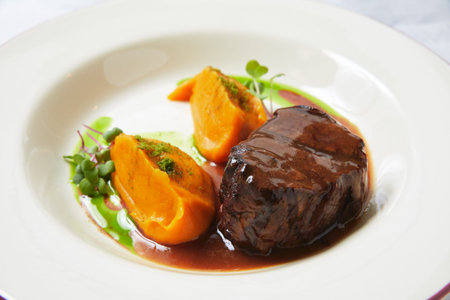 Delicious steak with batata pieces and microgreen on plate