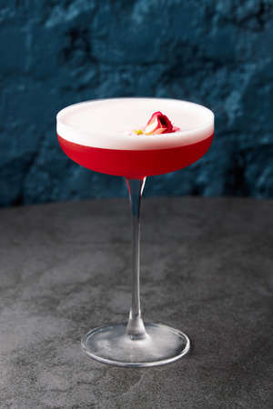 Dessert decorated with rose in glass bowl on grey tableの写真素材