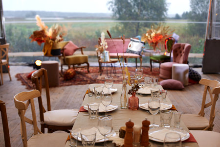 Served table with decor on empty terrace in restaurantの写真素材