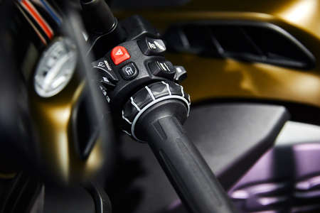 Motorcycle handle bar with buttons on blurred backgroundの写真素材