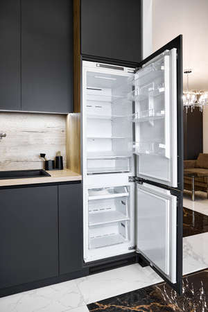Contemporary fridge with open doors in apartment studioの写真素材