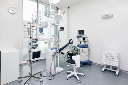 Examining chair and appliances near window in dentist clinicの写真素材
