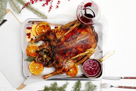 Christmas dish baked duck with oranges served on white table
