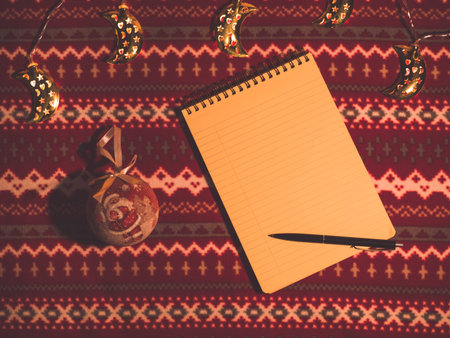 Christmas flat lay. Note and decoration on pattern holiday table. New year's background