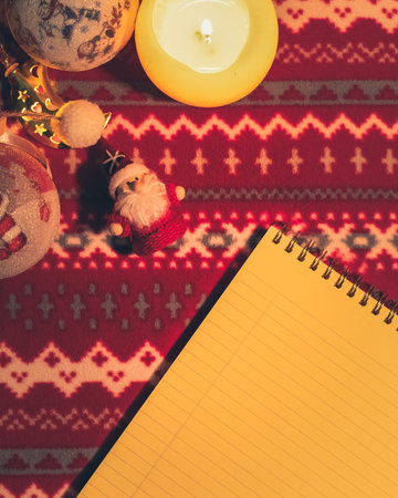 Christmas flat lay. Note and decoration on pattern holiday table. New year's background