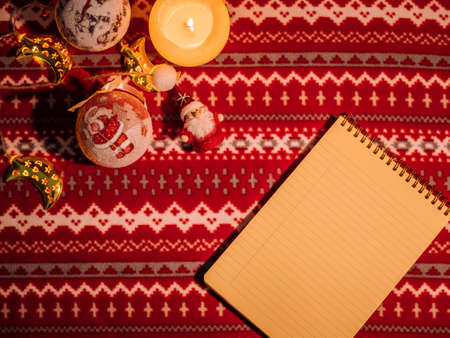 Christmas flat lay. Note and decoration on pattern holiday table. New year's backgroundの写真素材