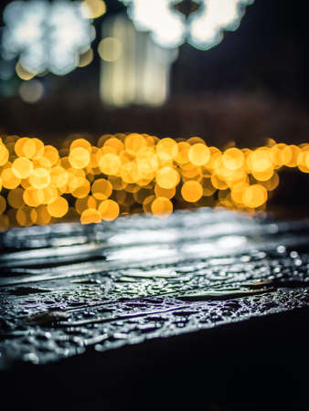 Water drops on the table with yellow bokeh backgroundの写真素材