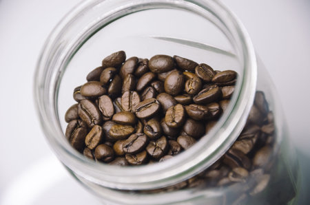 Closeup of beautiful coffee beans in transparent bottle