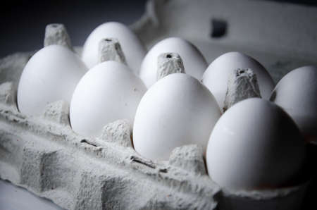 Closeup of white chicken eggs on the white tableの写真素材