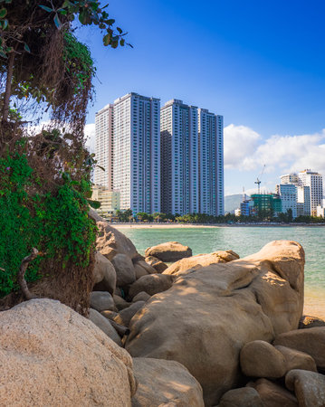 Rocks on the bayside with big city background. Tourist place with nice view. Summer vacation near oceanの写真素材