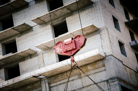 Crane works on the construction of a new house
