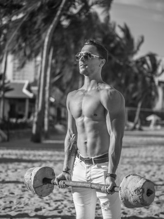 Muscle man training on the beachの写真素材