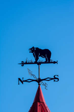 A bear weathervane. Side of the world against the skyの写真素材