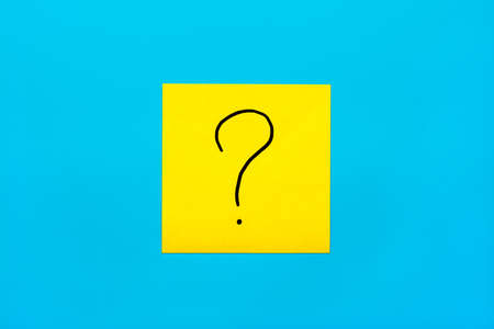Forget, reminder, combination of colour concept- Close up black handwritten symbol of question mark on one yellow square sticker on blue background with copy spase, horizontal orientation.の写真素材
