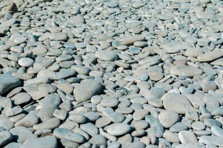 Pebble beach on a sunny summer day, background, selective focusの写真素材
