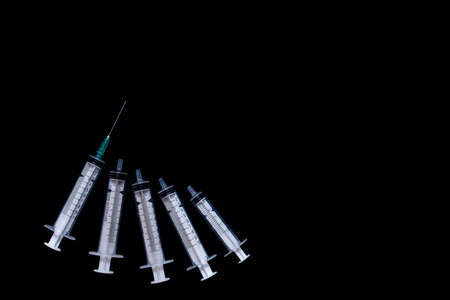 Medical syringes on a black background, isolate, copy spaceの写真素材