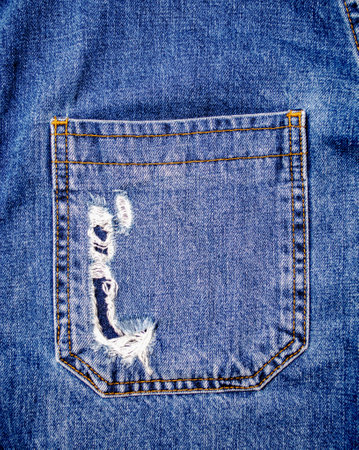 Worn Torn Back Pocket of Blue Denim Jeans for Fashion Design and Textile Texture Referenceの写真素材