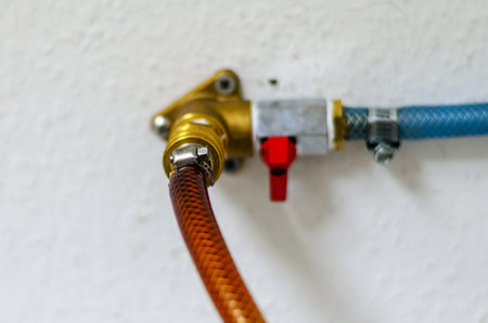 This image shows a detailed view of a water valve assembly, highlighting its components and connectionsの写真素材