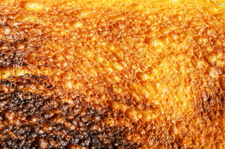 This macro shot captures the intricate details of perfectly toasted bread, highlighting its delicious texture and colorの写真素材