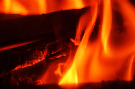 The fiery scene captures the intense heat and vibrant colors of a roaring fire, perfect for cozy...