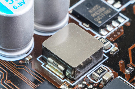 Macro close up of a MOSFET component on a dusty motherboard. Shows accumulated dust on computer...