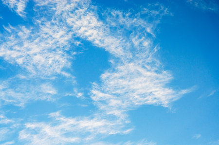 Beautiful blue sky with fluffy white clouds on a bright sunny dayの写真素材