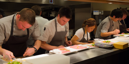 Group of professional chefs preparing food in the kitchen of a restaurant or hotelの素材
