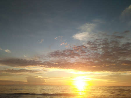 Sunset. Dramatic sunset sky with clouds. Dramatic sunset over the seaの写真素材