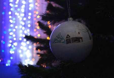 Beautiful, festive, Christmas, New Year's ball on a green spruce. flickering garlands in the backgroundの写真素材