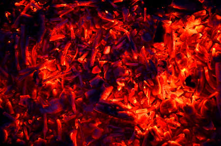 abstraction yellow-red coals smolder against the background of the night, the remains of firewoodの写真素材