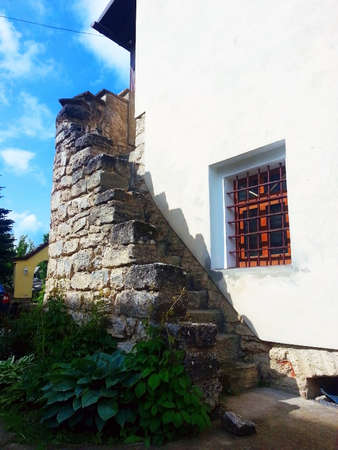 old, stone, spiral staircase behind the house. rear entrance to the houseの写真素材