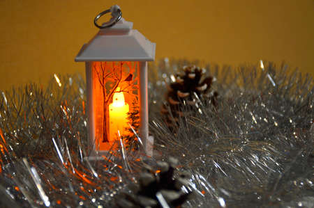 A white, decorative flashlight glows in the dark. wood drawing on glassの写真素材