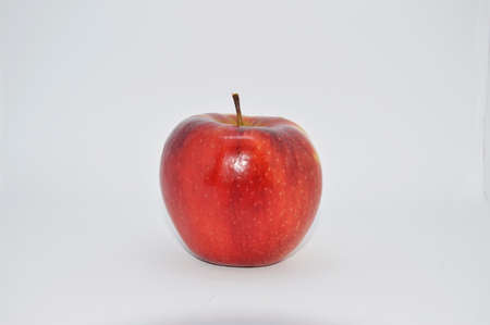 red, ripe, juicy apple on a white background. apple is a source of iron, vitamins and mineralsの写真素材