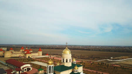 Orthodox church on the background of the citadel of the fortress and blue skyの写真素材