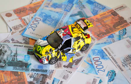 toy car with open doors on the background of Russian moneyの写真素材