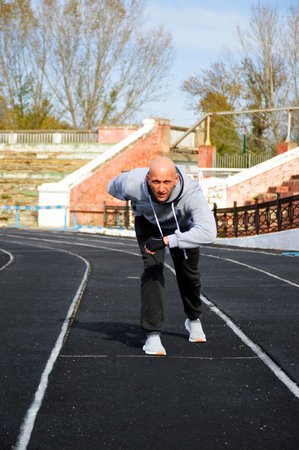 man getting ready to start on a treadmill, outdoor jogging workout