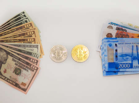 coins bitcoin, dollars and russian rubles on a white backgroundの写真素材