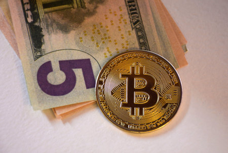 coins of bitcoin on banknotes of dollars. Exchange bitcoin cash for a dollar