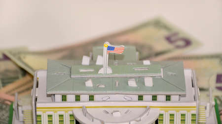 model of the White House of the President of the United States on the background of dollars. world currency and main economy of the worldの写真素材