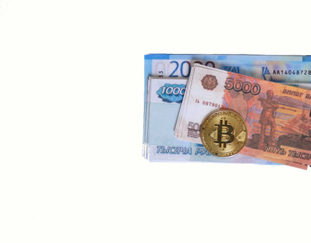 cryptocurrency bitcoin with money in Russian rubles on a white background. the concept of switching to cashless payments and the use of digital moneyの写真素材