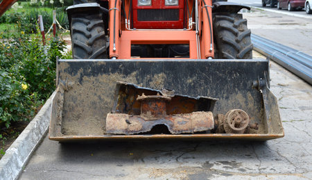 old rusty and corroded pipe holding in a tractor bucket. repair to replace iron pipes with plastic...