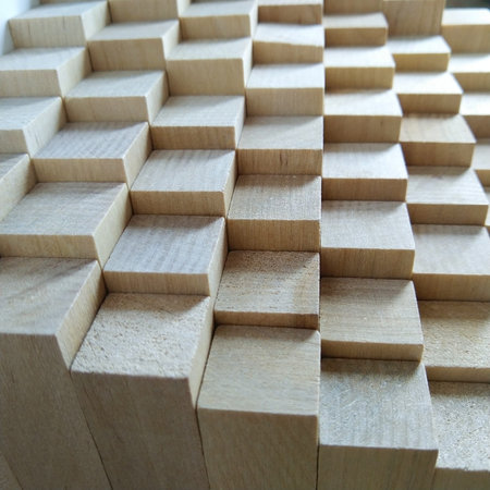 background or wall of wooden blocks of the same size. the perspective in the photo goes into the...