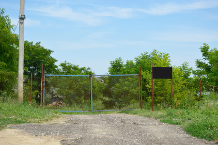 the rural dirt road leading to the private territory is blocked by a chain-link gate. prohibition of...