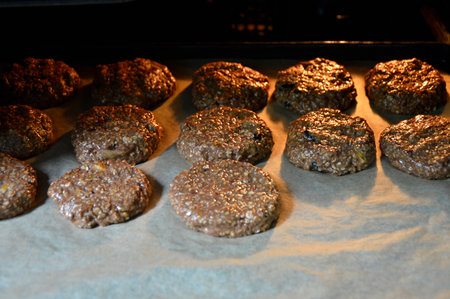 homemade oatmeal cookies are baked on parchment in the oven. cooking a delicious and healthy dessert for children and adultsの写真素材