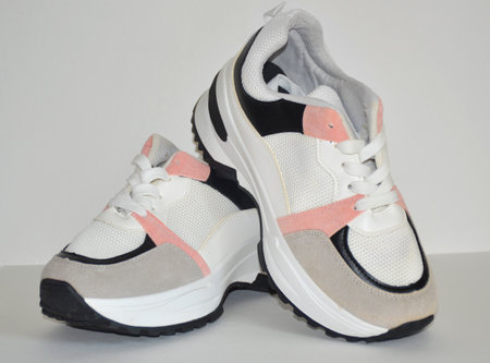 multi-colored female sneakers on a white background. Sports shoes. Casual shoes for sports and walking. youth style. Shoes for fitness, running, yogaの写真素材