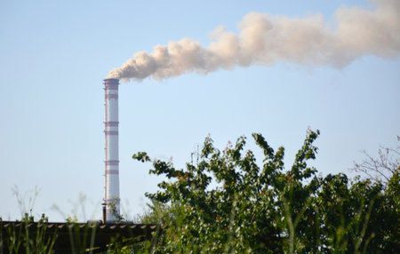 pipe of an industrial enterprise and emissions into the atmosphere. air pollution. environmental problems and global warming. climate change and pollutionの写真素材