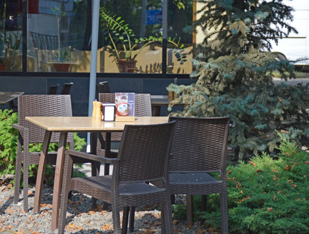 rattan table and chairs on the summer terrace of a street cafe. catering establishment. place to relax and have a snackの写真素材