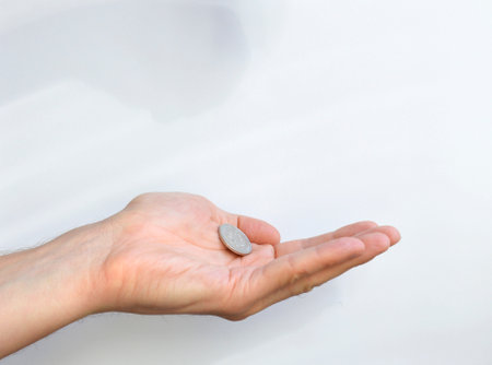 Russian coins on an open palm on a white background. there are coins in the hand. the balance of finances after paying for the purchase of goods or other payments. inflation and price increasesの写真素材